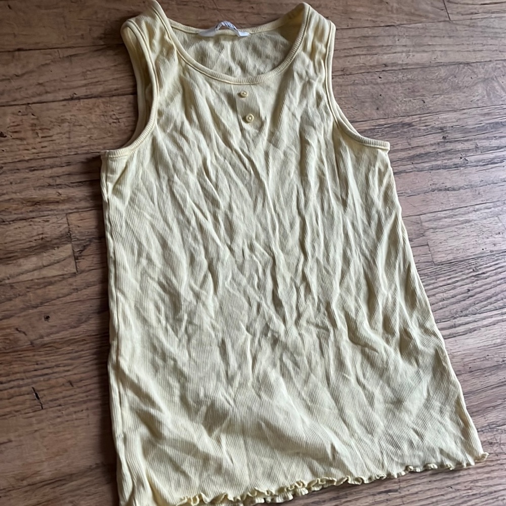 pastel yellow tank top, with buttons. ruffles at the bottom from H&M